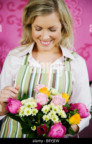 A blond woman working in a flower shop Sweden. Stock Photo