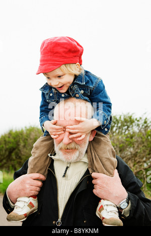 Grandfather carrying his grandchild on his shoulders Sweden. Stock Photo