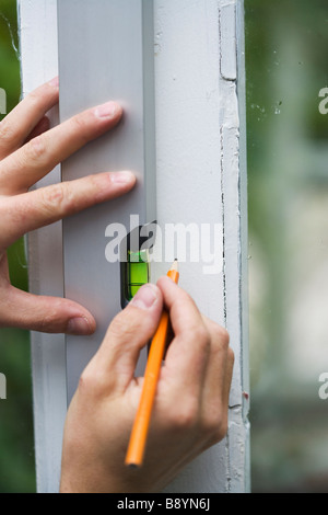 A man using a spirit level Sweden. Stock Photo