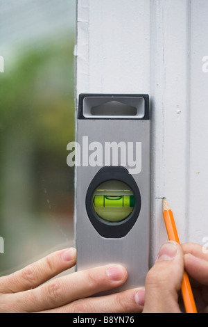 A man using a spirit level Sweden. Stock Photo