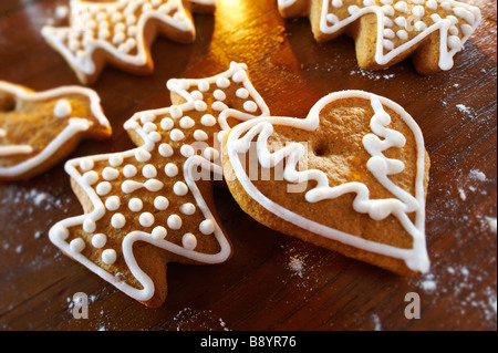 Fresh baked spicy christmas biscuits in s festive setting on a wooden table Stock Photo