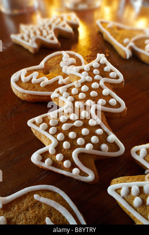 Fresh baked spicy christmas biscuits in s festive setting on a wooden table Stock Photo