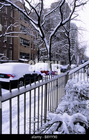 New York City Manhattan narrow side street after a heavy snowstorm. Snow drifts and parked cars after winter blizzard. USA Stock Photo