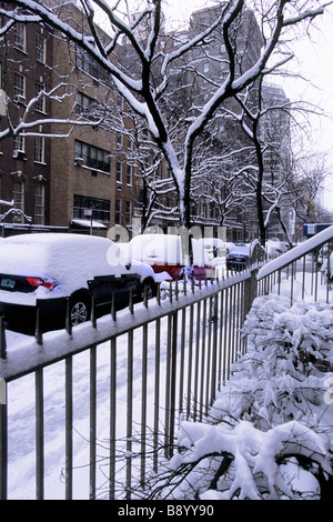 New York City street after a heavy snowstorm. Snow drifts and cars on a deserted side street in Manhattan Stock Photo