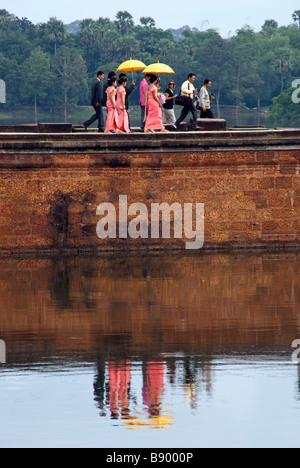 Cambodian wedding party at Angkor Wat, passing moat west of the temple Stock Photo