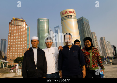 Muslim Uyghur family pose in front of the financial district of Pudong, Shanghai. Stock Photo