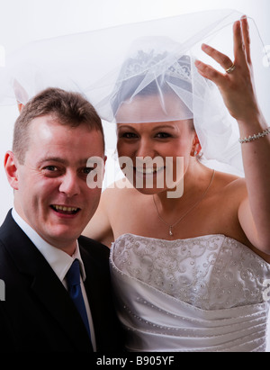 Bride and Groom on wedding day, marriage, bride in white wedding dress, gown with veil and tiara Stock Photo