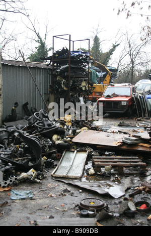 piled up spare parts and cars in breakers scrap yard Stock Photo