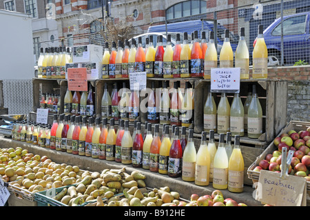 Bottles of organic juice on sale at Marylebone Farmers Market London England UK Stock Photo