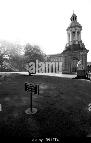 The Campanile in Dublin Trinity College with a sign in the foreground saying to keep off the grass Stock Photo