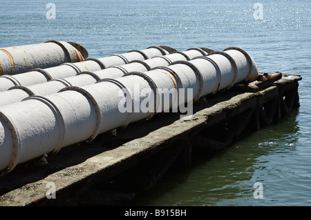 Sewage pipes leading to the river water Stock Photo
