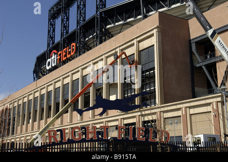 Workers install a finishing touch on the stadiums decorations at CitiField Stadium in Flushing, Queens, New York Stock Photo