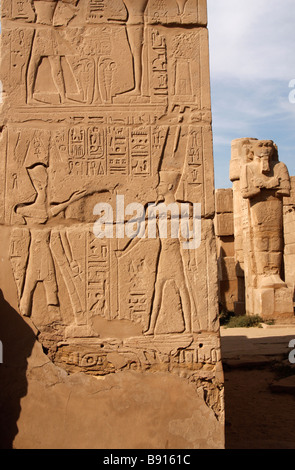 Ancient Egyptian hieroglyphics and wall relief showing pharaoh and god Amun, close up detail, Karnak Temple, Luxor, Egypt Stock Photo