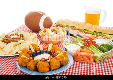 Table spread with appetizer trays for the footbal party Horizontal view over white background  Stock Photo