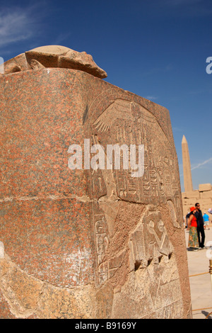 Sacred scarab beetle statue and stone plinth carved with hieroglyphics, obelisk behind, Karnak Temple, Luxor, Egypt Stock Photo