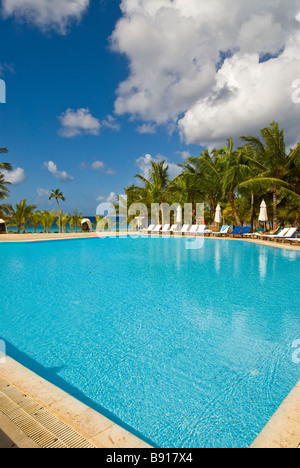 Deserted hotel swimming pool Bayahibe Dominican Republic Viva Wyndham Dominicus Palace all-inclusive resort with palm trees Stock Photo