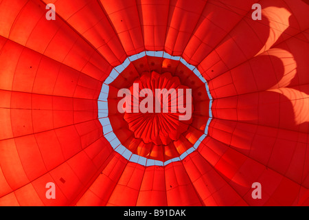 Inside a colourful red [hot air balloon] being inflated, close up detail Stock Photo