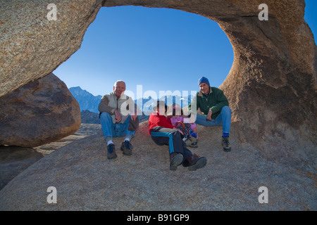 People sitting in natural arch. Stock Photo