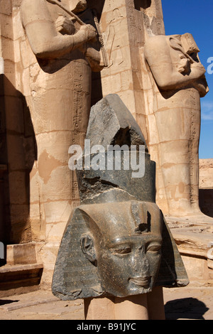 Carved granite head of Ramesses ii and osiris stone statues, The Ramesseum [mortuary temple], 'West Bank', Luxor, Egypt Stock Photo