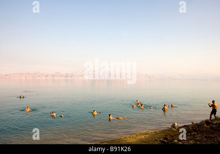 Man photographing tourists floating in Dead Sea, Israel, Middle East Stock Photo