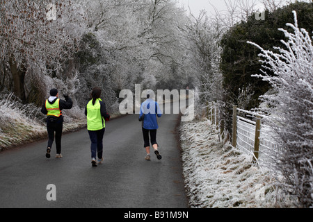 Jogging through the Dorset countryside covered with hoar frost hoarfrost at Dorset, UK in January Stock Photo