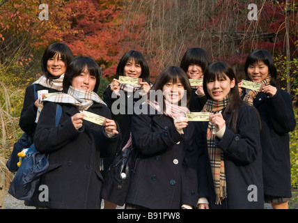 Japanese school girls hold their entry tickets to Ryoanji zen garden Kyoto Japan Stock Photo