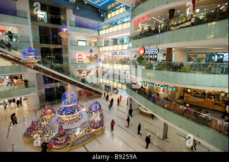 Interior of modern new Joy City shopping mall in Xidan district of Beijing China Stock Photo