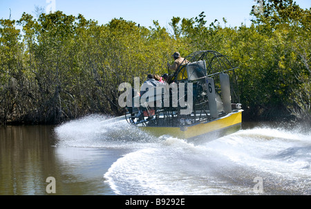 Airboat turning at speed in a channel near Everglades City Florida Stock Photo