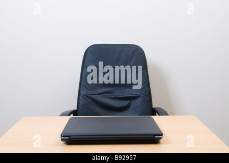 Leather chair and a laptop inside an office Stock Photo