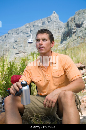 Man taking a break from hiking up Table Mountain Cape Town Western Cape Province South Africa Stock Photo