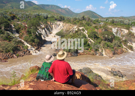 Couple admiring falls Epupa Falls Kunene River Kaokoland Namibia Stock Photo