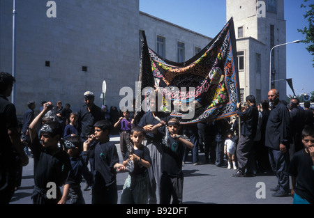 black clothed Shia Shiite Islamic religion Iranian custom Muslim Muslims Muharam  banner mourners self flagellating Isfahan Iran Stock Photo