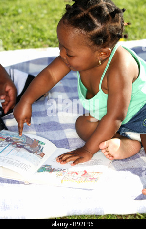 Baby girl pointing at pictures in a book Dewaal Park Cape Town Western Cape Province South Africa Stock Photo