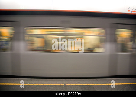 A U Bahn train speeds through an underground station in Vienna Austria Stock Photo