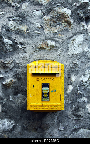 yellow post box on wall, French post box Stock Photo