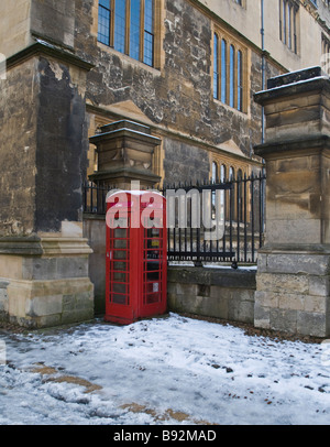 Red coin fed telephone box outside an Oxford College in England after a heavy snow fall in February 2009 Stock Photo