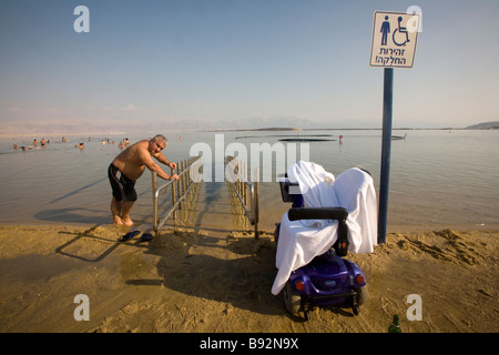 Man leaning against disability ramp in Dead Sea, Israel, Middle East Stock Photo
