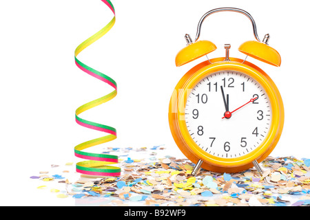 Waiting the New Year with clock confetti and ribbons Shallow depth of field Stock Photo