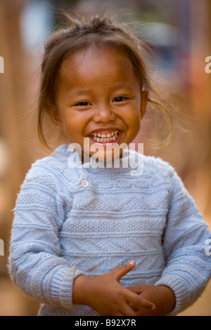 Young Cambodian girl smiling, photographed at Skuom Market on the road to Angkar Wat Stock Photo