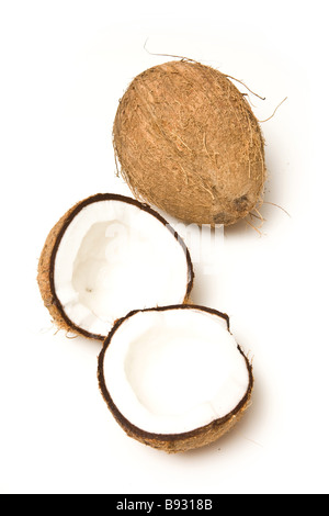 Coconuts halved and whole isolated on a white studio background Stock Photo