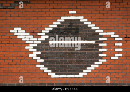 Detail of teapot pattern on red brick wall Stock Photo