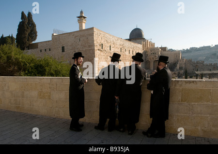 Ultra orthodox Jewish men stand in front of El Aksa Mosque at the old city, East Jerusalem Israel Stock Photo