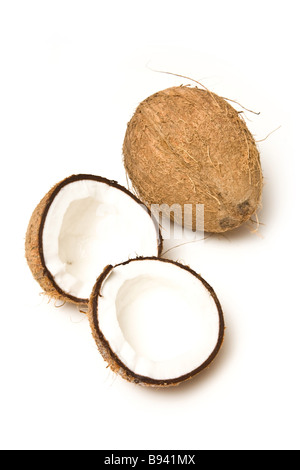 Coconuts halved and whole isolated on a white studio background Stock Photo