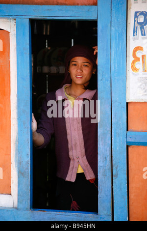 Annapurna Nepal 19 March 2008 Young girl in indow of her shop shed selling food and drinks to trekkers on the annapurna circuit Stock Photo