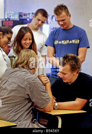 Relaxing after class two high school boys arm wrestle while classmates watch in Mission Viejo CA Stock Photo