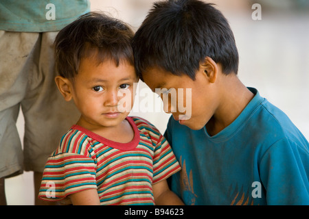 Portrait of two young brothers with fishing rods standing with an arm  around each other Stock Photo - Alamy