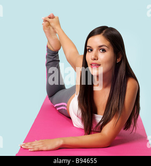Young attractive woman in yoga posture, wearing sportswear bra and