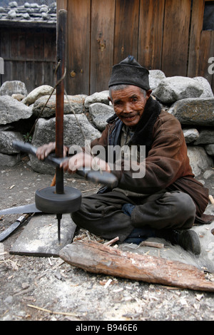 Annapurna Nepal 20 March 2008 Old man repairing his farming tools in village Stock Photo