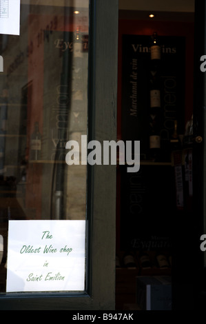 A sign in a shop window stating the oldest Wine shop on St Emilion The picturesque village of St Emilion Bordeaux France Stock Photo