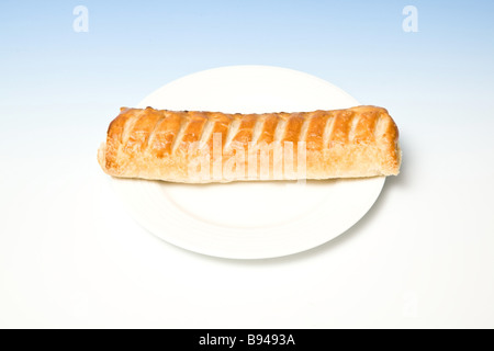 Sausage roll on a white plate. Stock Photo